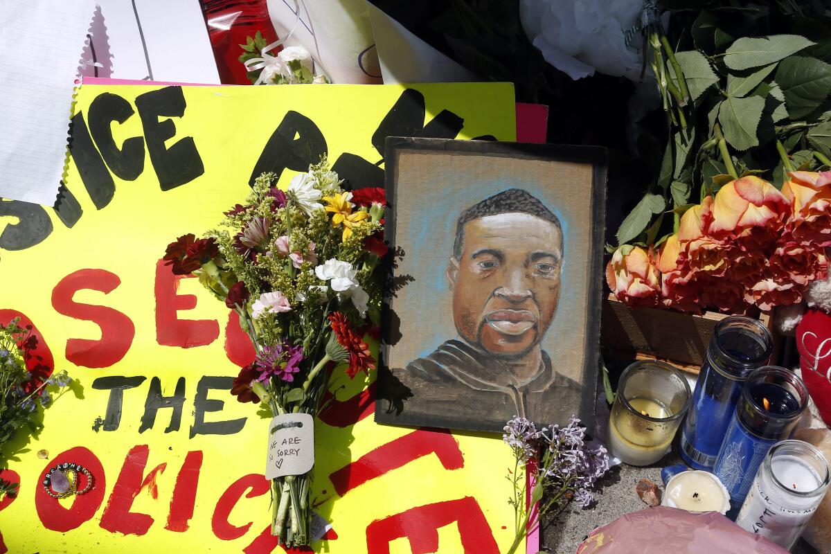 A portrait of George Floyd is part of a memorial for him near the site of where he died in police custody in Minneapolis.