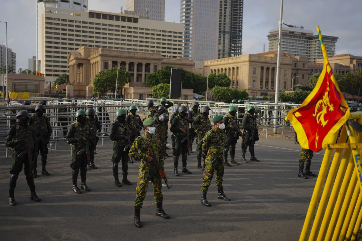 Police commandoes and army soldiers stand guard outside the president's office, after troops and police cleared the main camp of protestors following months of demonstrations, in Colombo, Sri Lanka, Saturday, July 23, 2022. (AP Photo/Eranga Jayawardena)