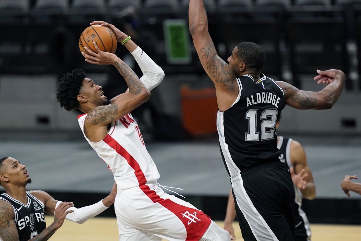 Houston Rockets center Christian Wood shoots against San Antonio Spurs center LaMarcus Aldridge.