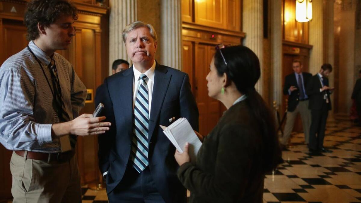 Sen. Lindsey Graham (R-S.C.) talks with reporters before attending the weekly Senate Republican Caucus policy luncheon at the Capitol.