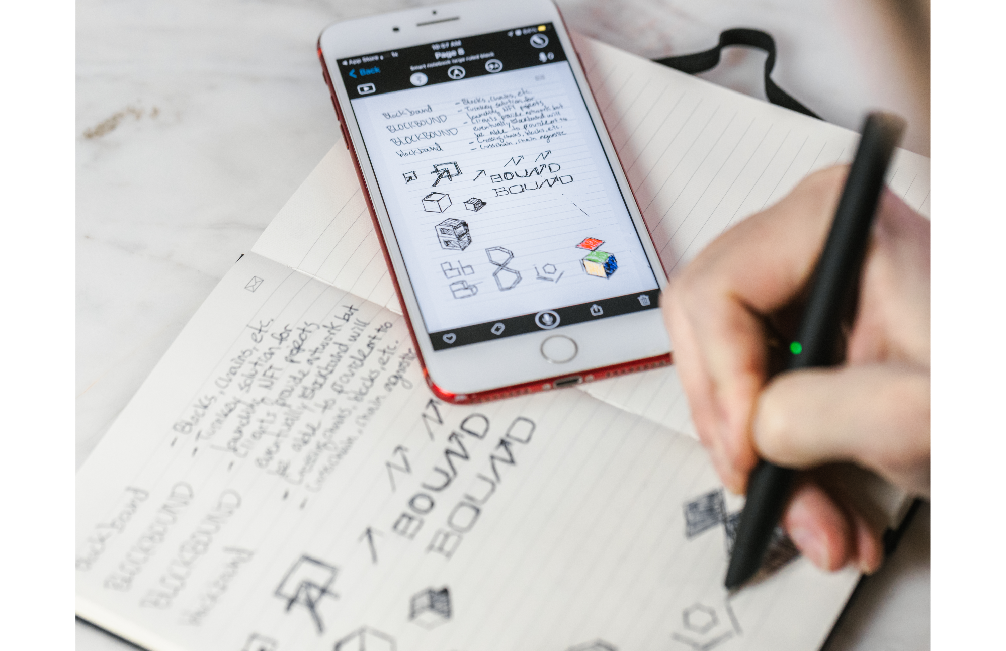 A person writes a note with the Moleskine Smart Writing Set