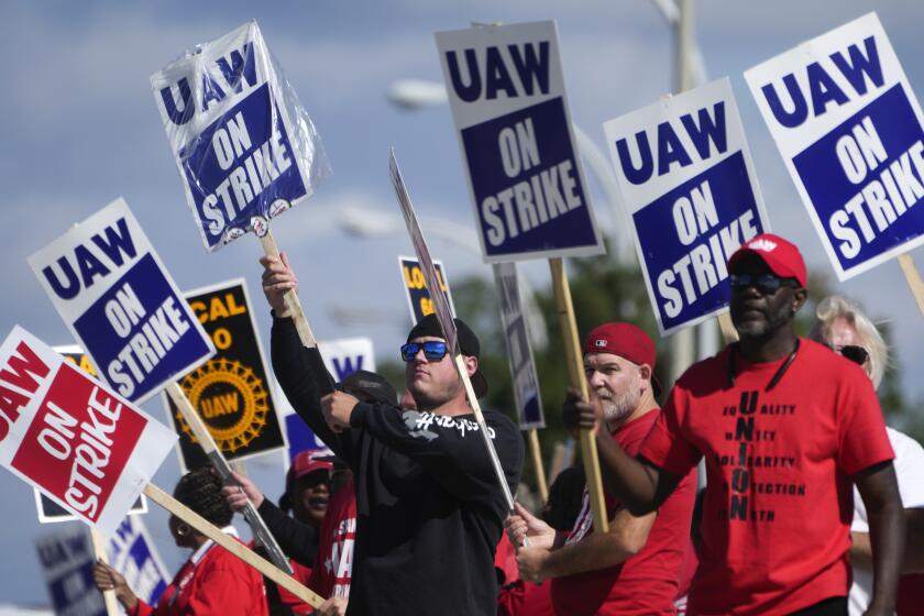 United Auto Workers members walk the picket line at the Ford Michigan Assembly Plant in Wayne, Mich., Monday, Sept. 18, 2023. So far the strike is limited to about 13,000 workers at three factories — one each at GM, Ford and Stellantis. (AP Photo/Paul Sancya)