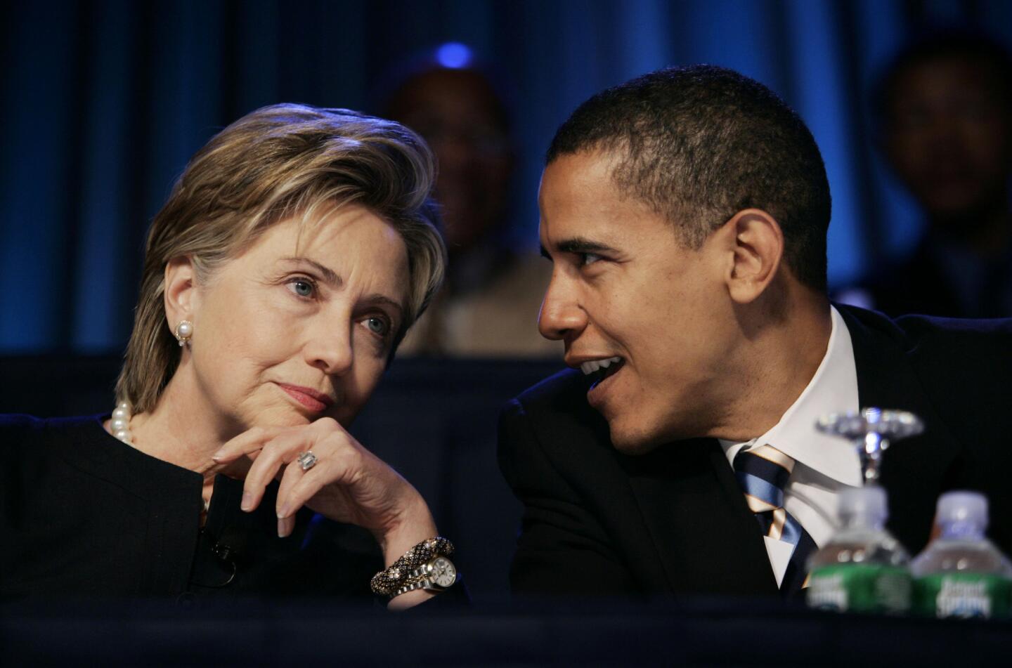 Then-U.S. Sen. Barack Obama speaks with then-U.S. Sen. Hillary Clinton during the annual convention of the National Association for the Advancement of Colored People.