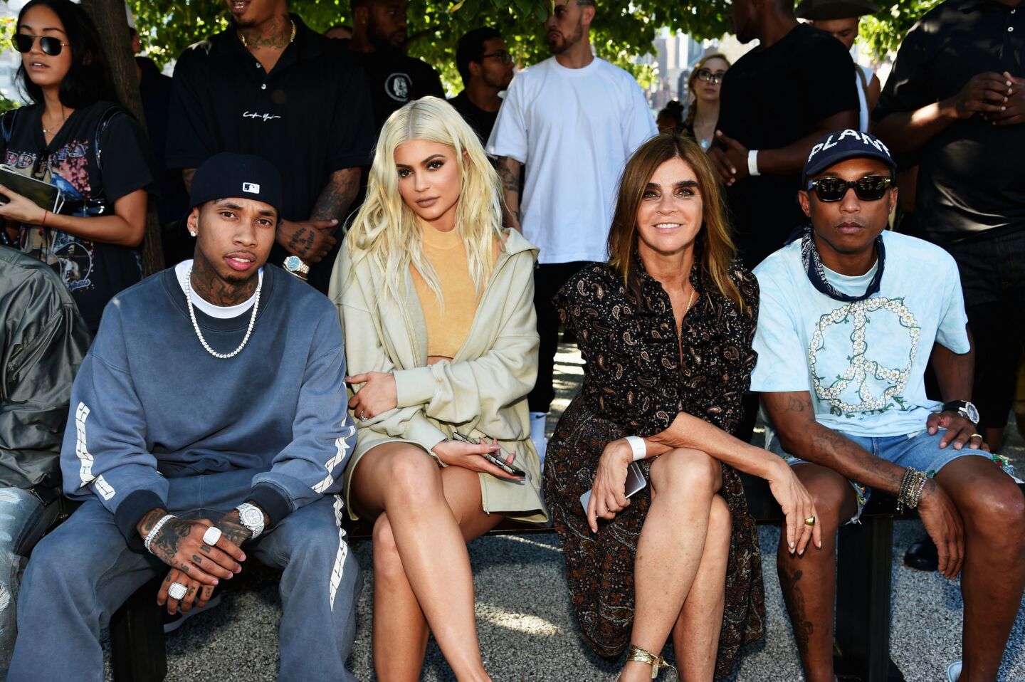 Tyga, left, Kylie Jenner, Carine Roitfeld and Pharrell Williams attend the Kanye West Yeezy Season 4 fashion show.
