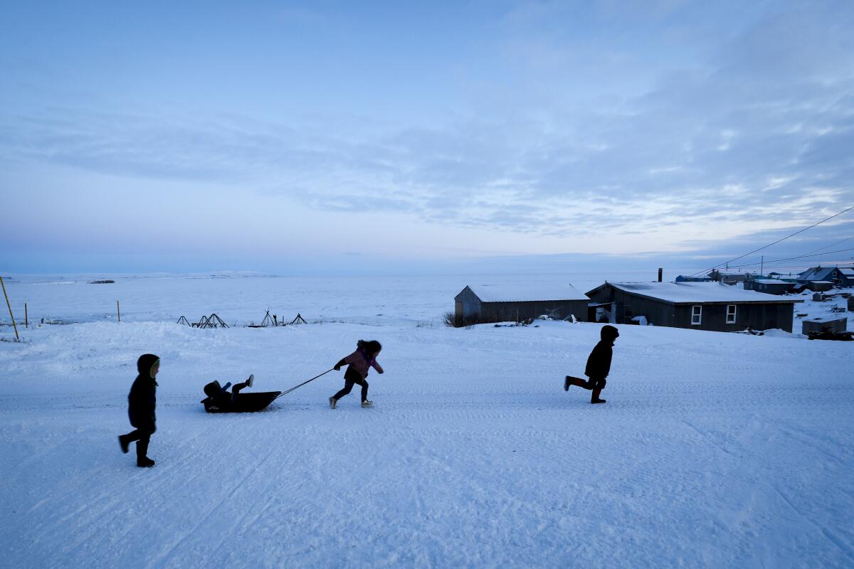 Children play in the snow in Toksook Bay, Alaska, where, beginning Tuesday, the first Americans will be counted in the 2020 census.