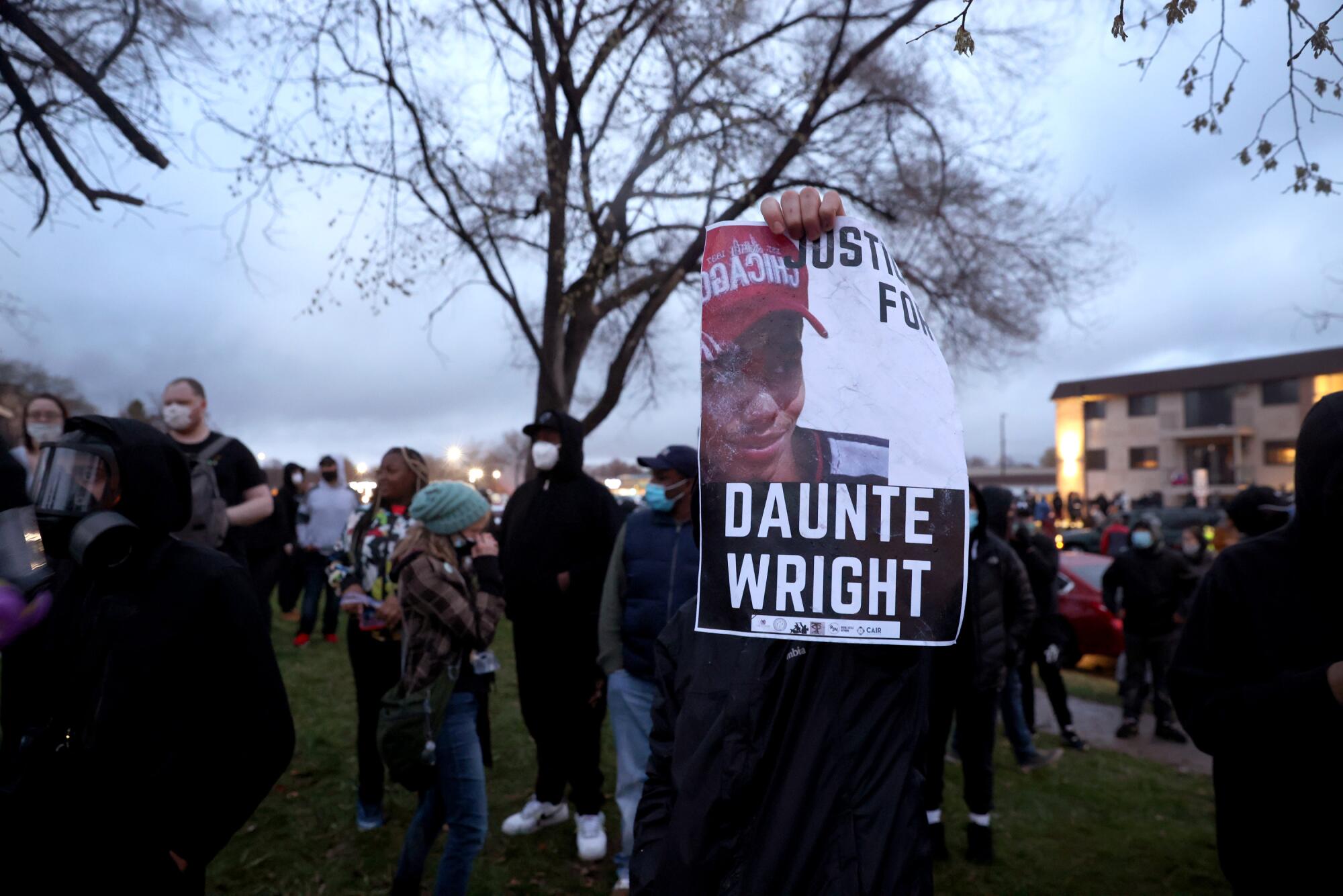 A sign held up by one person in a crowd reads "Justice for Daunte Wright"