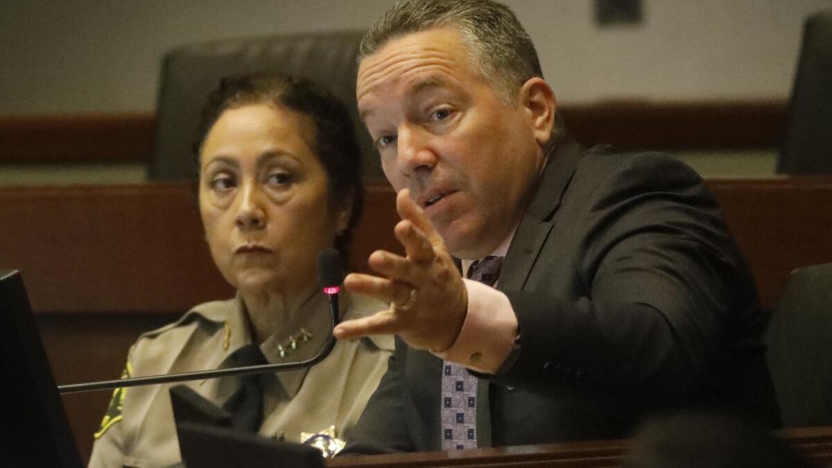 Sheriff Alex Villanueva, right, addresses the issue of Secret Deputy Sub-groups as new Assistant Sheriff Robin Limon looks on during the Sheriff Civilian Oversight Commission at the Metropolitan Transit Authority in Los Angeles on March 26.