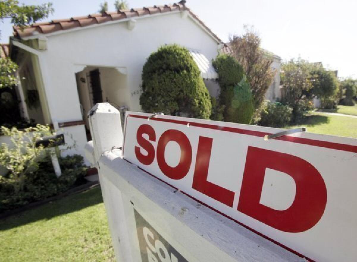 A "sold" sign is seen outside a home in Los Angeles.