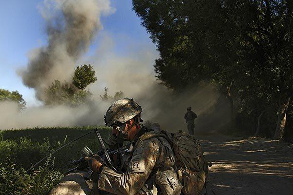 U.S. Army Pfc. Preston Young alerts the command post of a blast that struck his patrol in the farmland of Afghanistan's Arghandab Valley.