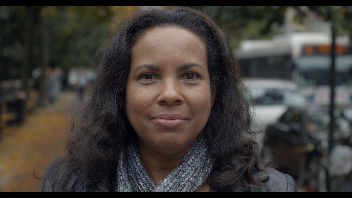 A close up of a woman slightly smiling