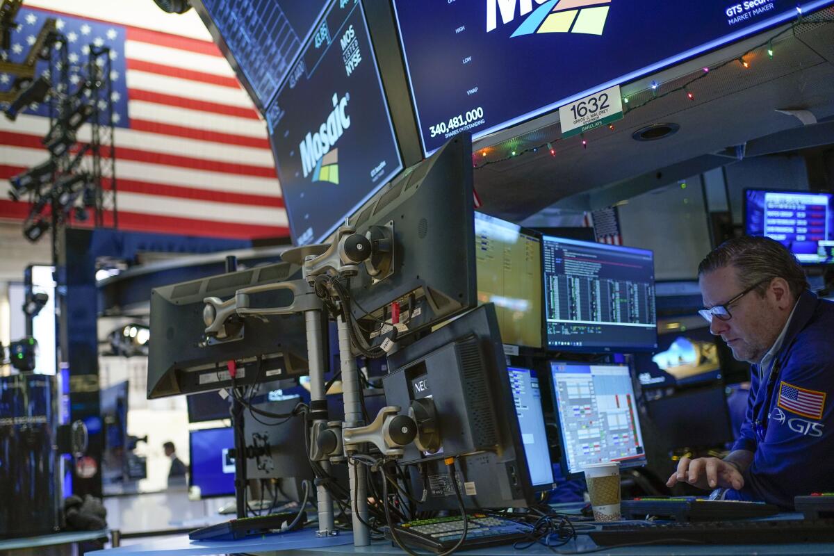 Traders work at computers on the floor at the New York Stock Exchange