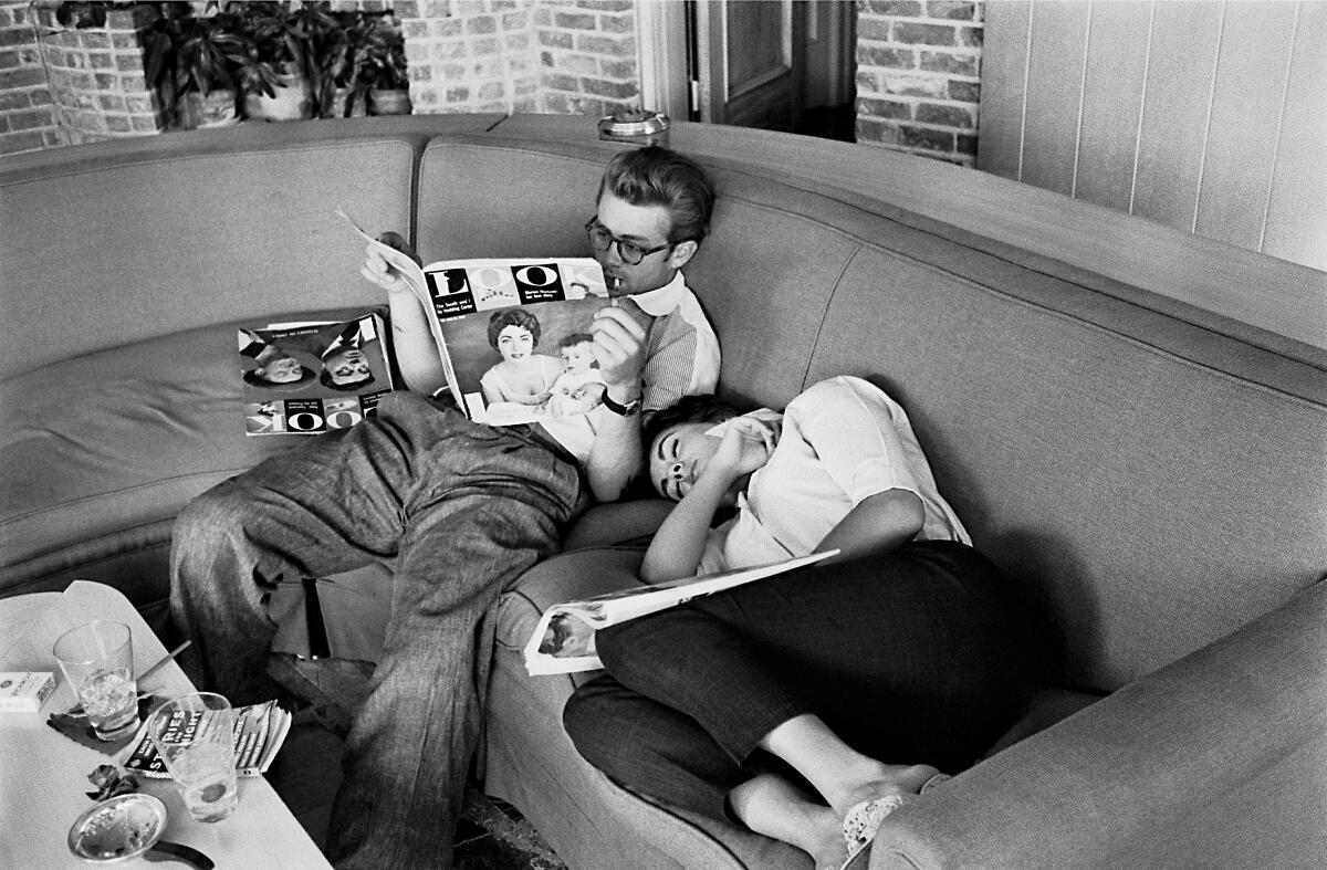 Elizabeth takes a nap next to James Dean, another Giant costar, during a break from filming. 