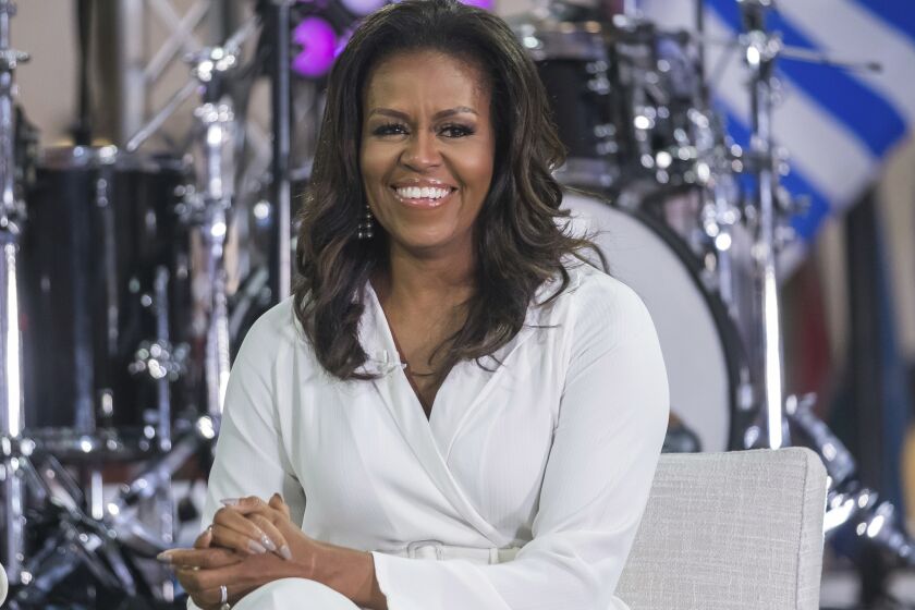FILE - In this Oct. 11, 2018 file photo, Michelle Obama participates in the International Day of the Girl on NBC's "Today" show in New York. Oprah Winfrey and Reese Witherspoon will be among the special guests when Michelle Obama goes on tour for her memoir Becoming. (Photo by Charles Sykes/Invision/AP, File)
