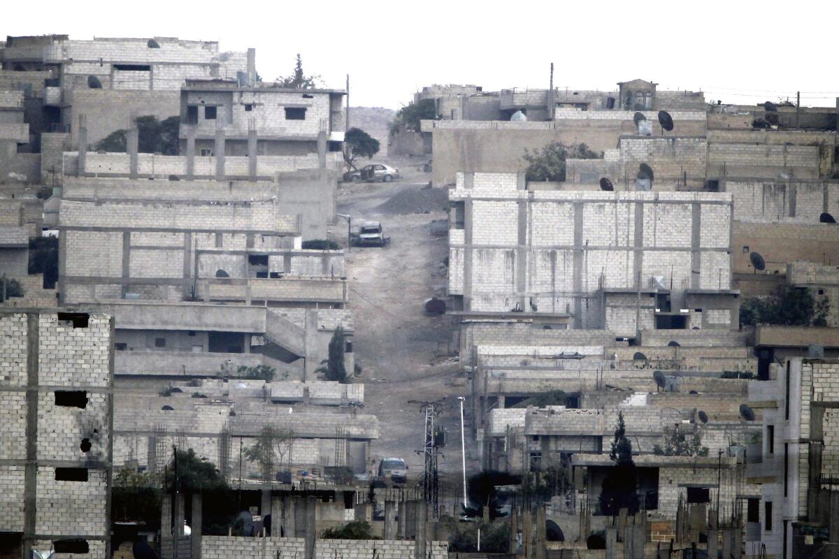 A view from the outskirts of Suruc, on the Turkey-Syria border, shows abandoned houses in the Syrian city of Kobani on Oct. 14 after fighting between Syrian Kurds and militants from the Islamic State.