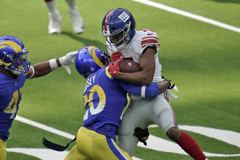 New York Giants wide receiver Golden Tate, right, is tackled by Los Angeles Rams cornerback Jalen Ramsey.