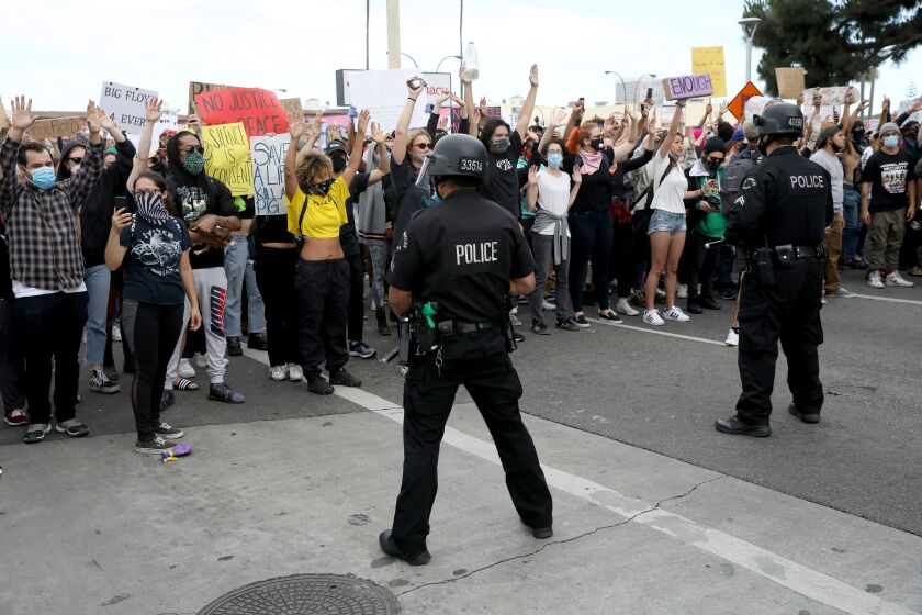 LOS ANGELES, CA -- MAY 30: Los Angeles police contain protestors as they demonstrate at W 3rd St and S Fairfax Ave. in the Fairfax District on Saturday, May 30, 2020, in Los Angeles, CA. The protestors demonstrate in response to the death of George Floyd in Minnesota. Last night more than 500 arrests after looting and vandalism sweep downtown L.A. (Gary Coronado / Los Angeles Times)