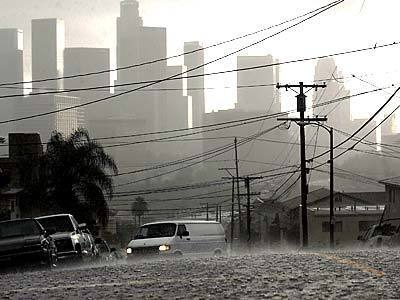 A motorist navigates a flooded street as rain pelts downtown Los Angeles.
