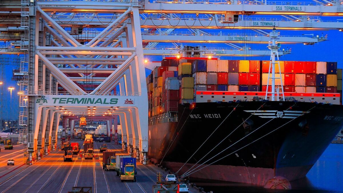 Containers are unloaded from a ship at the Port of Los Angeles. A plan by Southern California air quality regulators relies on voluntary measures for ports, warehouse distribution centers and other freight pollution hubs.