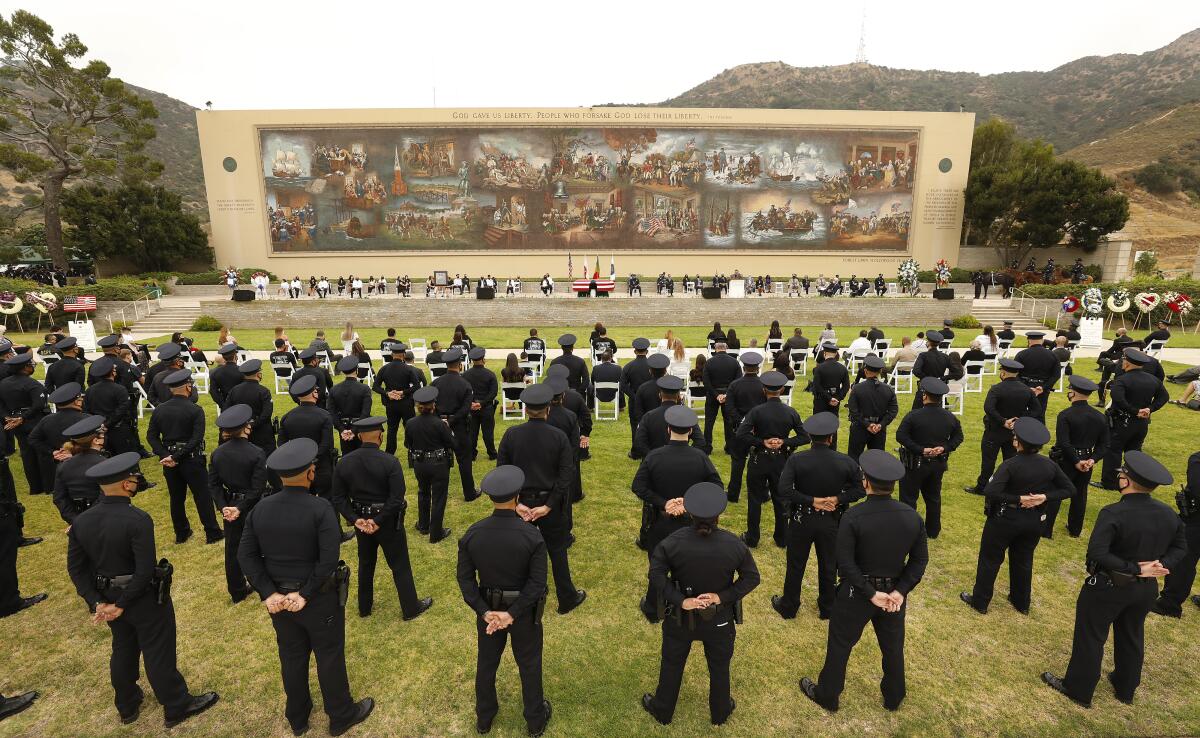 LAPD officers and others attend a funeral.