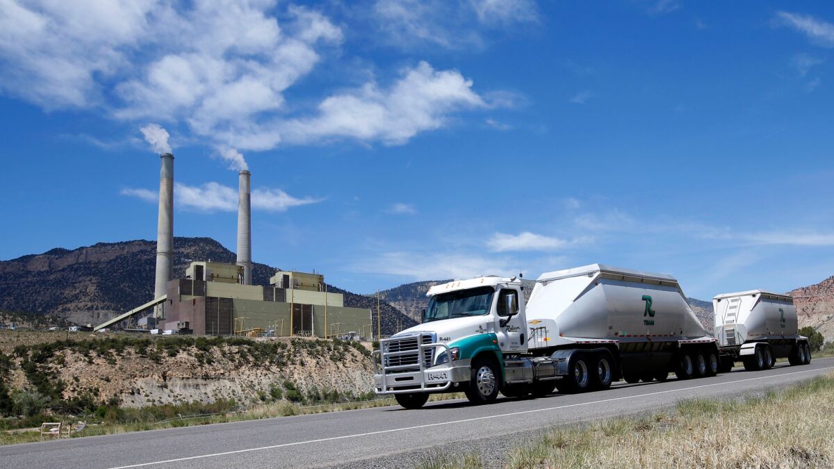 A coal truck leaves the Huntington Power plant outside Huntington, Utah, this month.