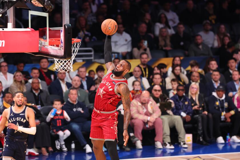 LeBron James dunks during the NBA All-Star Game on Sunday at Gainbridge Fieldhouse in Indianapolis