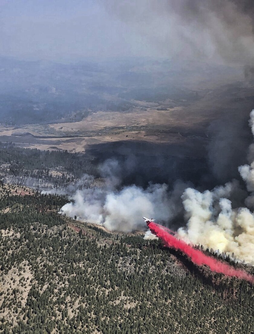 FILE - This Saturday, Sept. 4, 2021, aerial photo provided by the United States Forest Service Lassen National Forest shows the Great Basin Team 1 Air Attack operations on the Dixie Fire on the Horton Ridge in Plumas County, Calif. Pacific Gas & Electric power lines sparked last summer's Dixie Fire in Northern California that swept through five counties and burned more than 1,300 homes and other buildings, state fire officials said Tuesday, Jan. 4, 2022. (Great Basin Team 1 Air Attack Operations/U.S. Forest Service via AP, File)