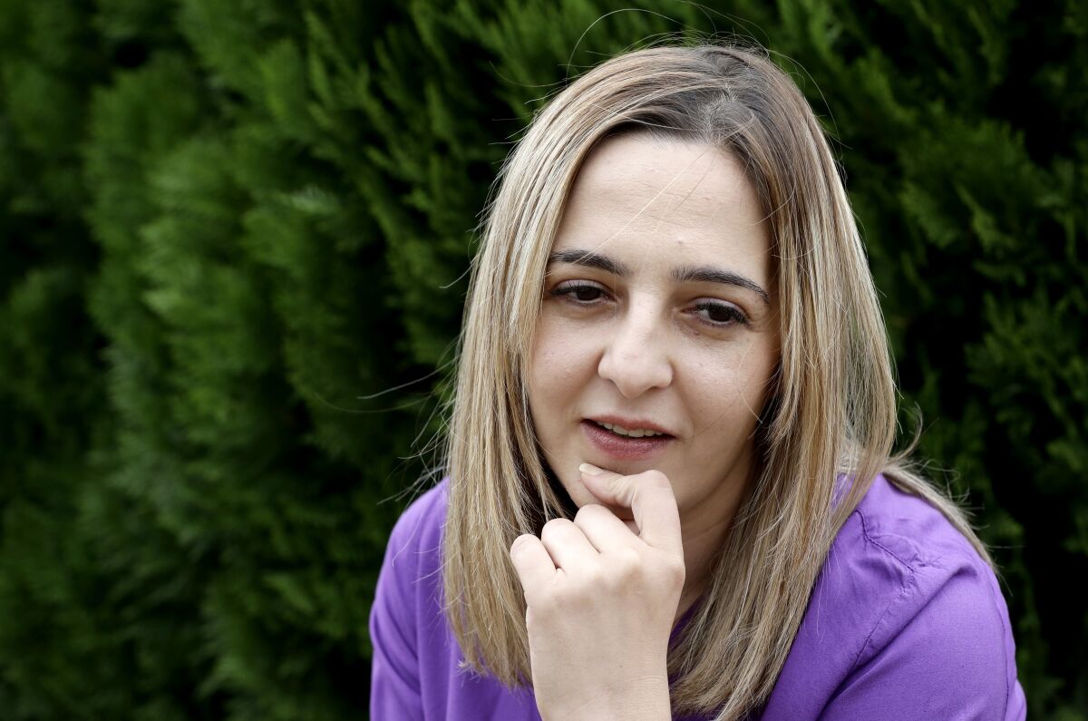 This Tuesday, Feb. 25, 2020, photo shows Aya Al-Umari, whose brother Hussein Al-Umari was killed in the Al Noor mosque shooting, at her home in Christchurch, New Zealand. Fifty-one people were killed and dozens more injured when a lone gunman attacked two mosques in Christchurch last year. New Zealanders on Sunday, March 15, will commemorate those who died on the first anniversary of the mass killing, as the tragedy continues to ripple through the community. Three people whose lives were forever altered that day say it has prompted changes in their career aspirations, living situations and in the way that others perceive them. (AP Photo/Mark Baker)