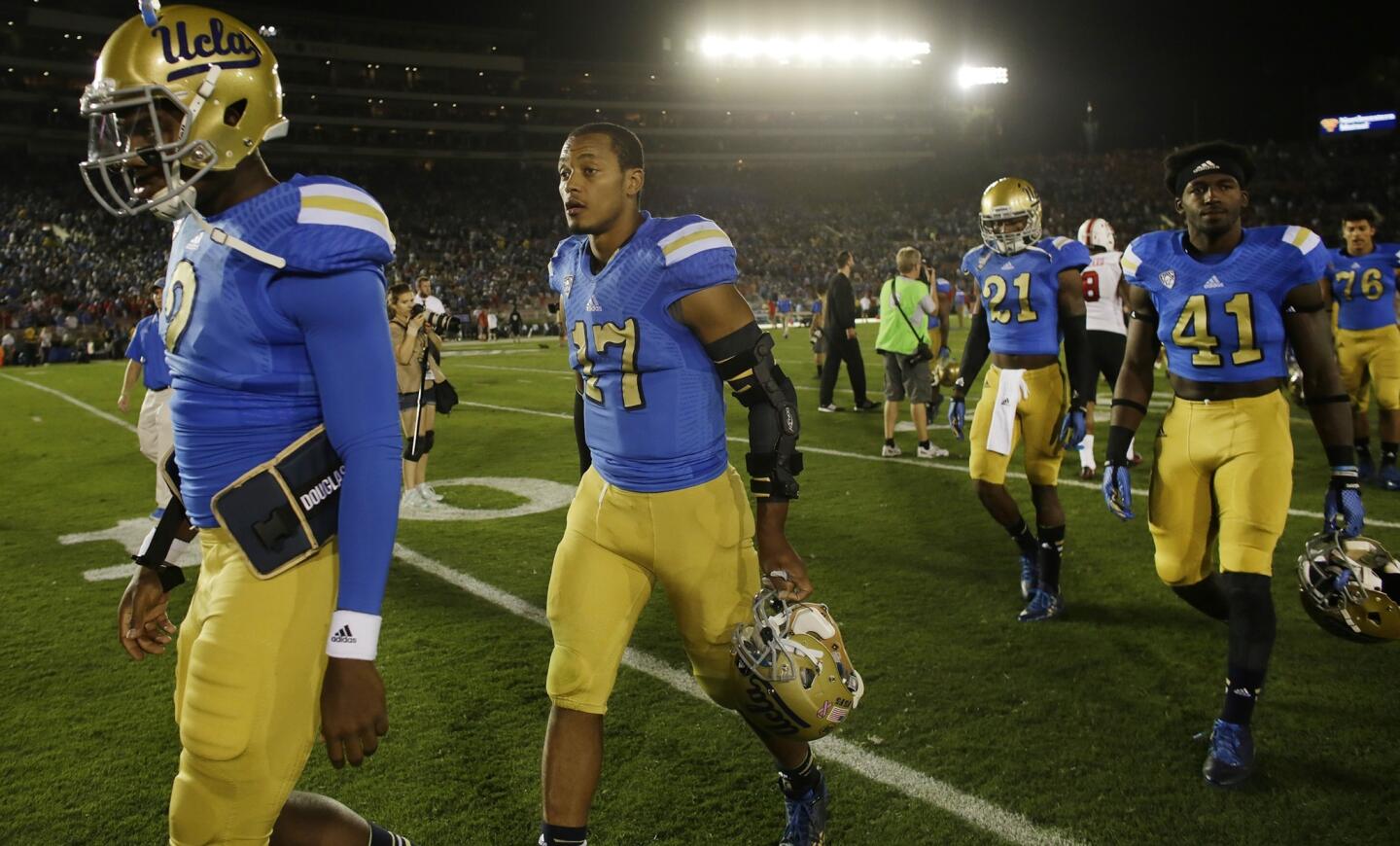 UCLA quarterback Brett Hundley (17) and his teammates leave the field after last weekend's 30-28 loss to Utah at the Rose Bowl.