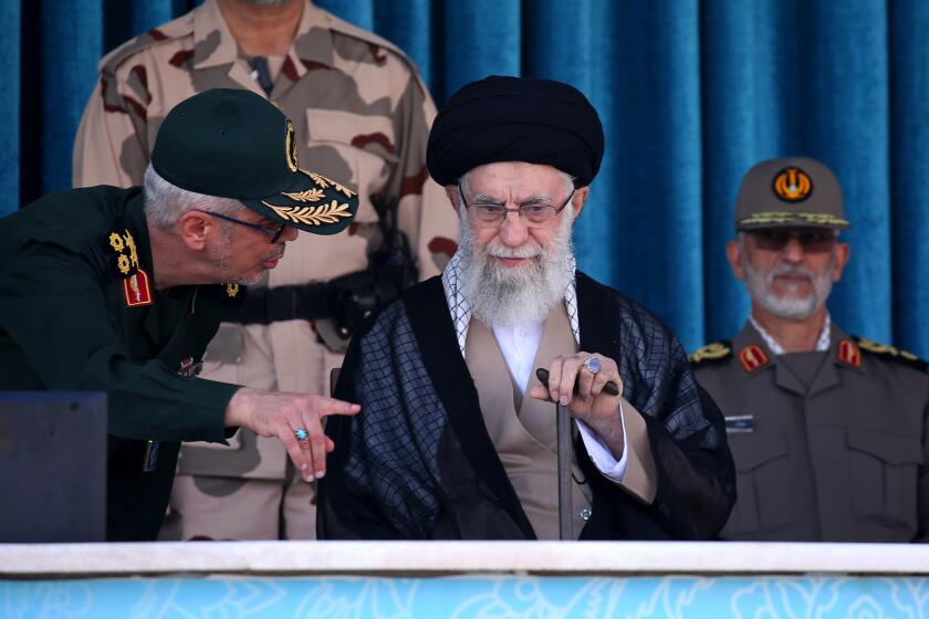 In this picture released by the official website of the office of the Iranian supreme leader, Supreme Leader Ayatollah Ali Khamenei, center, listens to chief of the General Staff of the Armed Forces Gen. Mohammad Hossein Bagheri at a graduation ceremony for a group of armed forces cadets at the police academy in Tehran, Iran, Monday, Oct. 3, 2022. Khamenei responded publicly on Monday to the biggest protests in Iran in years, breaking weeks of silence to condemn what he called “rioting” and accuse the U.S. and Israel of planning the protests. (Office of the Iranian Supreme Leader via AP)