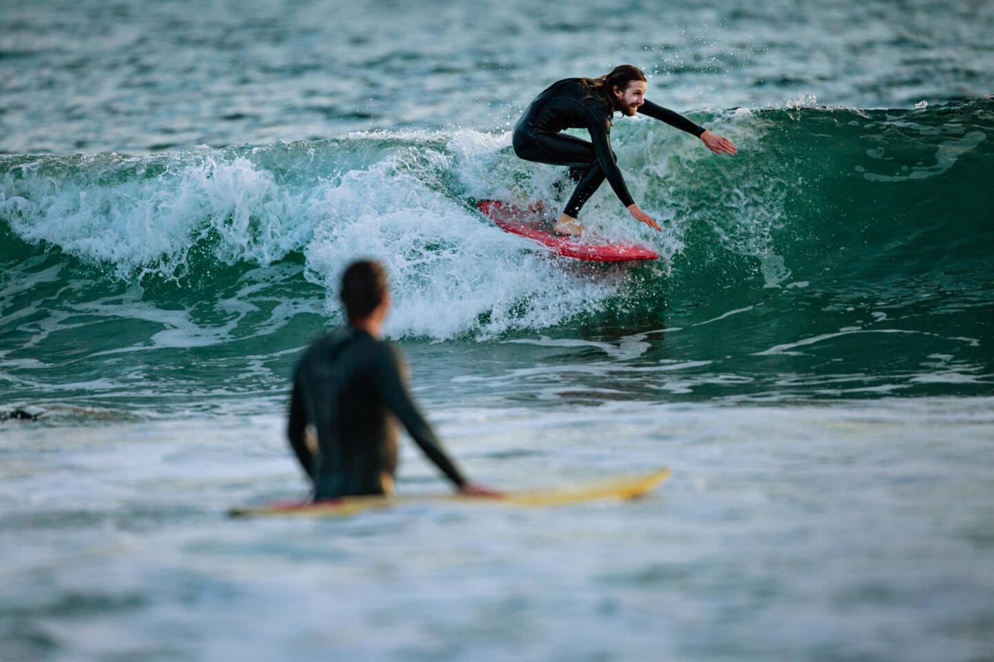 Surfers keep active at Venice beach on Thursday.