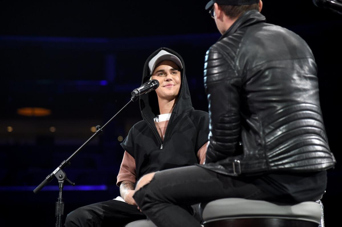 Justin Bieber, left, and Judah Smith speak onstage Nov. 13 during "An Evening with Justin Bieber" at Staples Center.