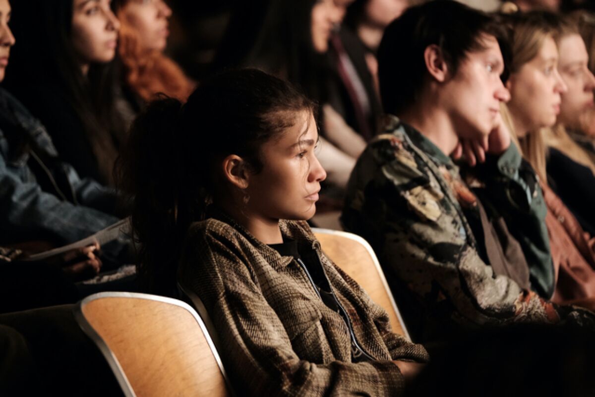 A young woman in the audience at a play