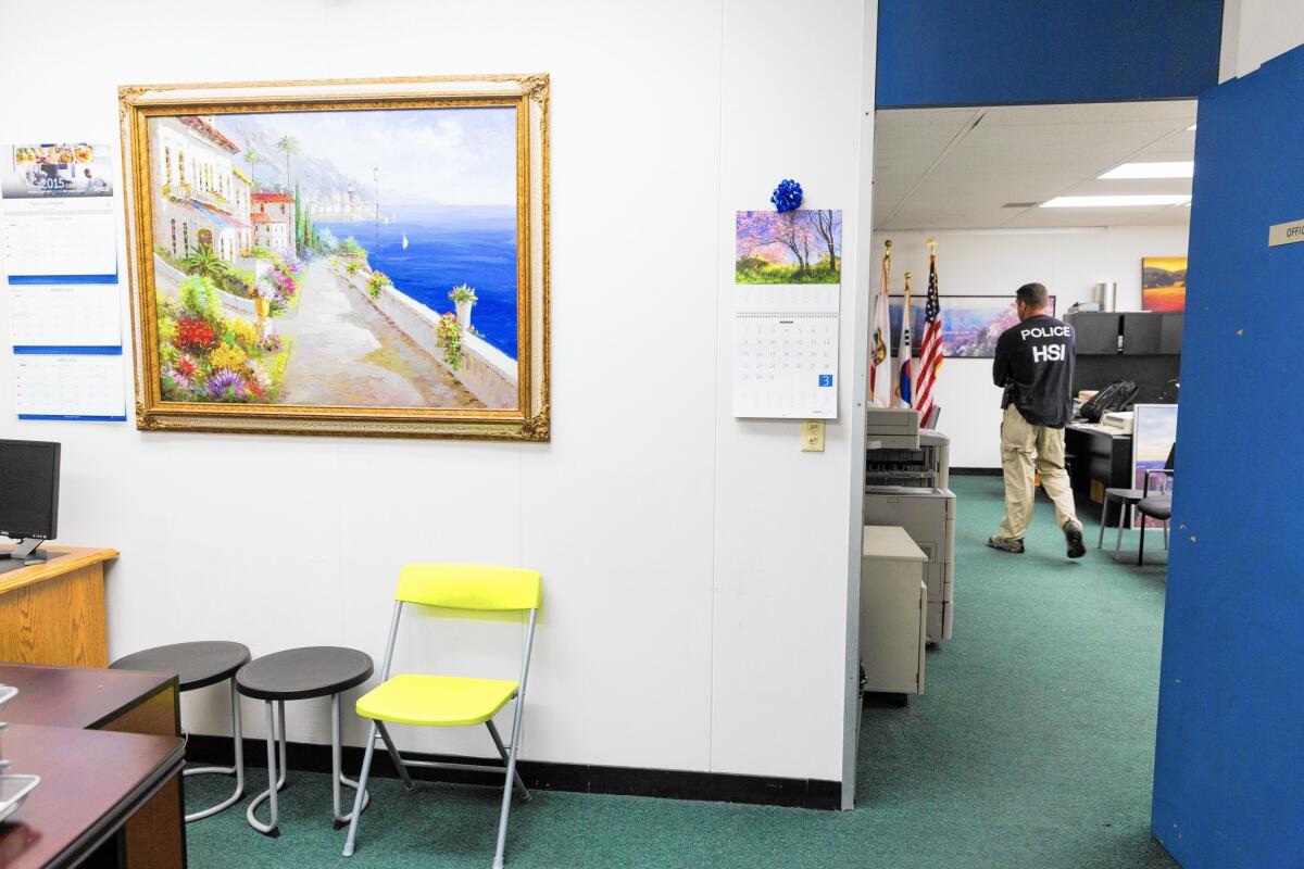 A Homeland Security Investigations officer at the administrative office area of Prodee University in L.A., which authorities say was one of four schools that allowed foreign nationals to illegally remain in the U.S. on fraudulent student visas.