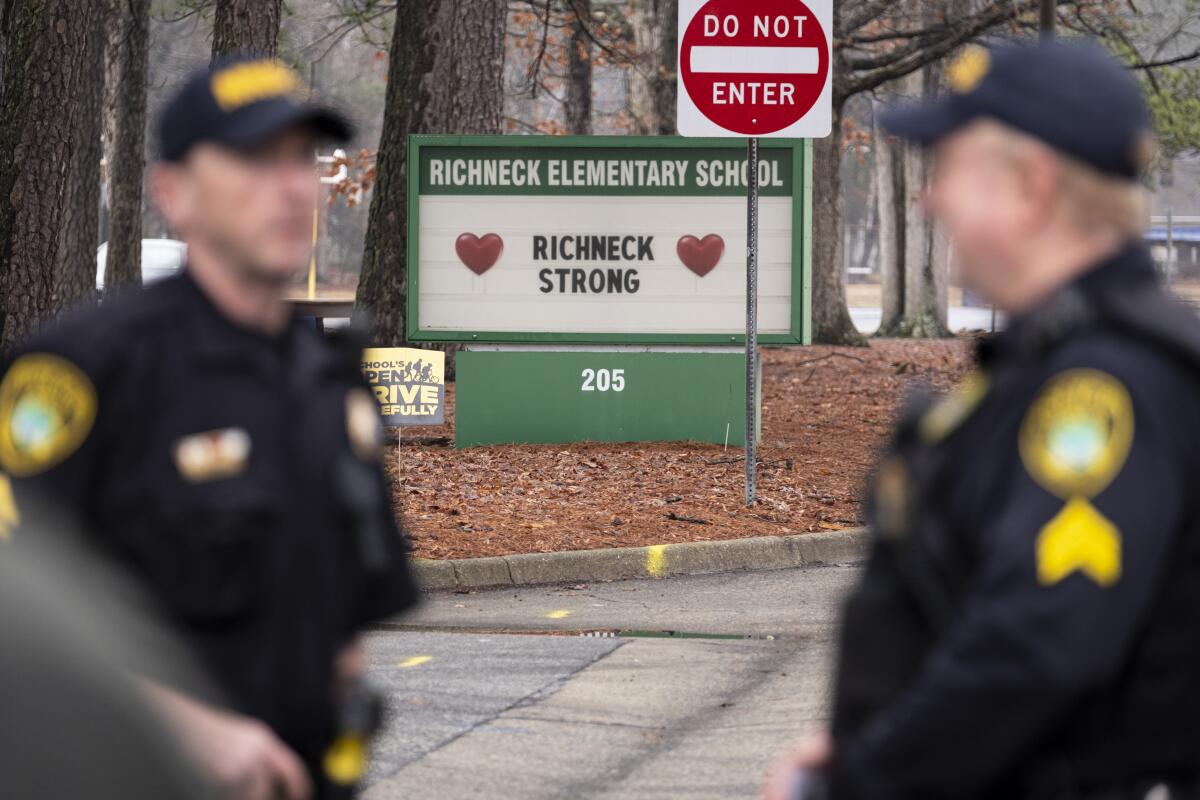 Police look on as students return to Richneck Elementary.