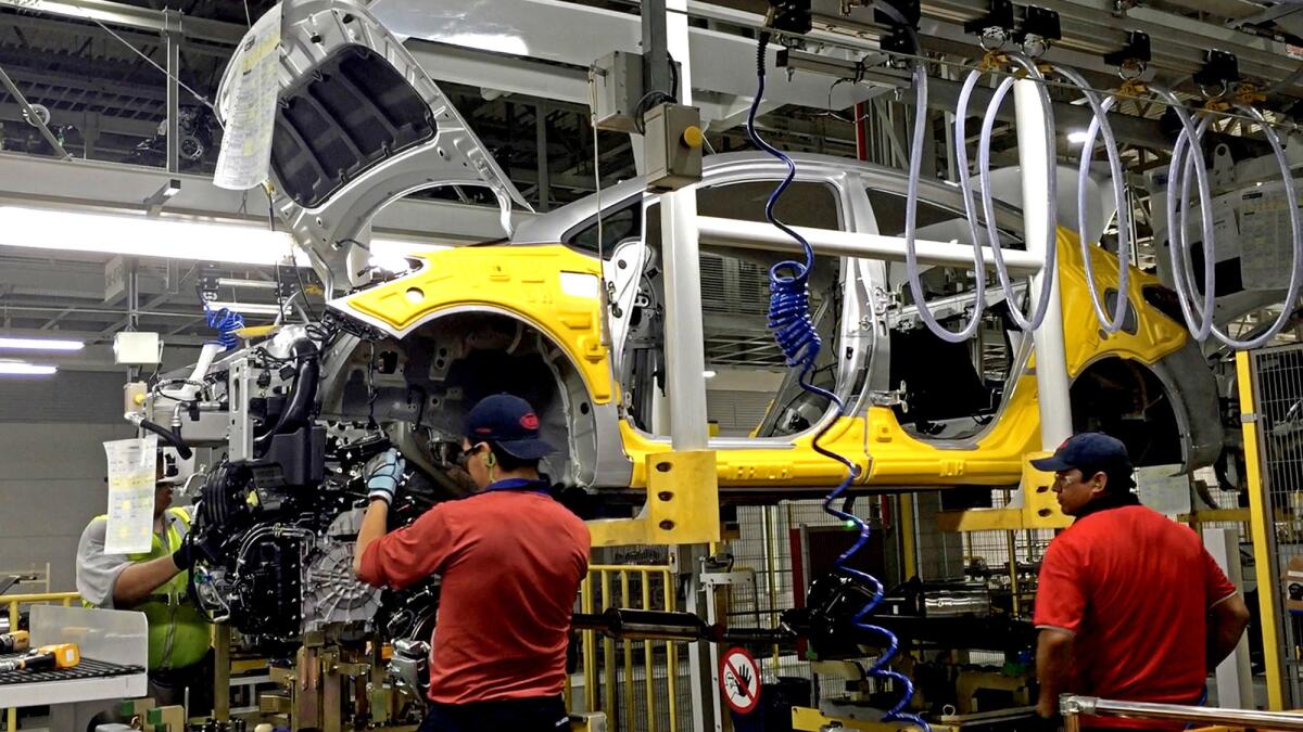 Workers assemble the Forte sedan at a Kia plant in Nuevo Leon, Mexico. Even in Mexico, with its lower labor costs, machines are replacing people.