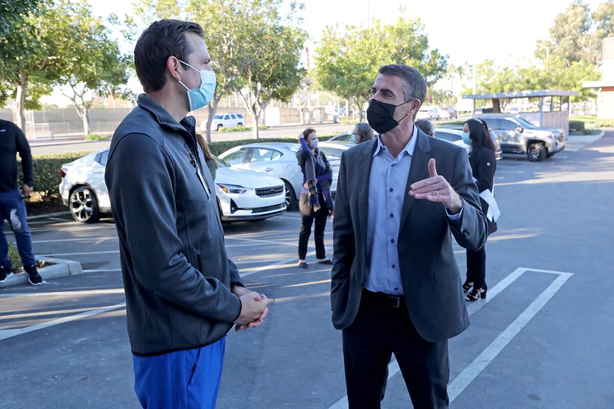 Exer Urgent Care CEO Rob Mahan, right, speaks to emergency medicine Dr. Jeff Laterreur during Wednesday's grand opening.