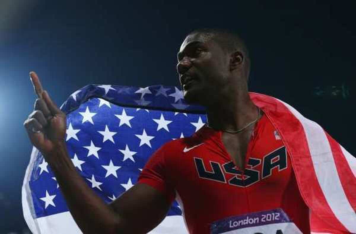 Justin Gatlin celebrates winning a silver medal in the 400-meter relay at the 2012 London Games.