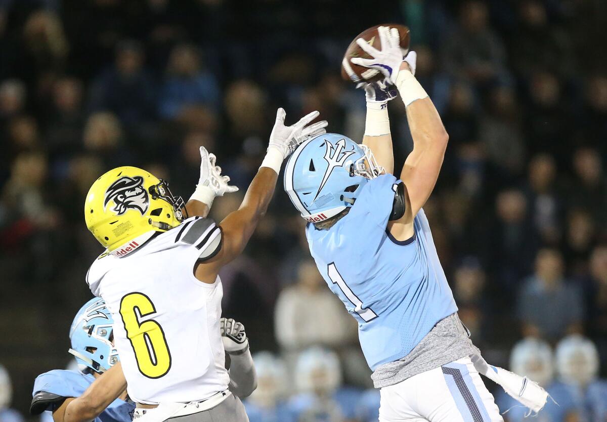 Corona del Mar cornerback Chandler Fincher jumps in front of Cajon receiver Larenzo McMillan for an interception during the quarterfinals of the CIF Southern Section Division 3 playoffs on Saturday.