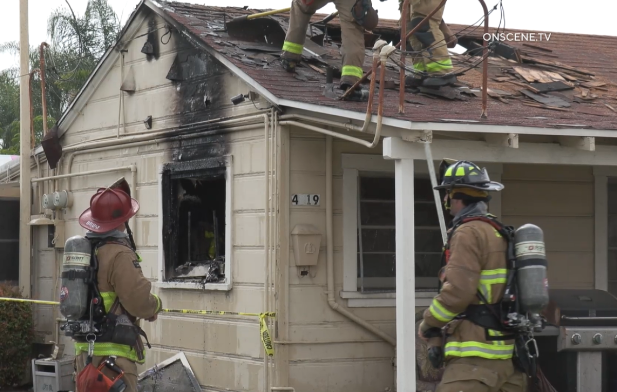 Firefighters worked to put out a fire at a La Mesa home that displaced four residents early Monday.