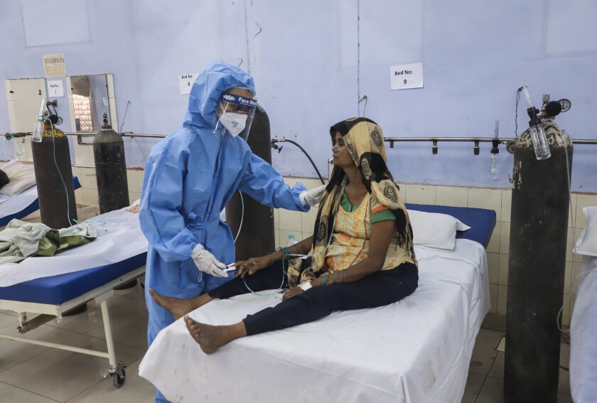 A nurse attends to a patient at a free COVID-19 care center being operated by a Sikh voluntary organization in Ghaziabad, outskirts ofNew Delhi, India, Monday, May 17, 2021. (AP Photo/Amit Sharma)
