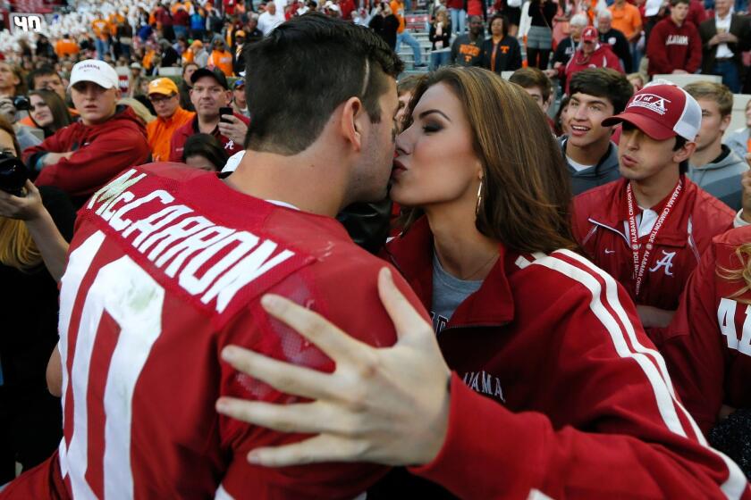 Katherine Webb kisses Alabama quarterback AJ McCarron after the Crimson Tide's win over Tennessee last month.