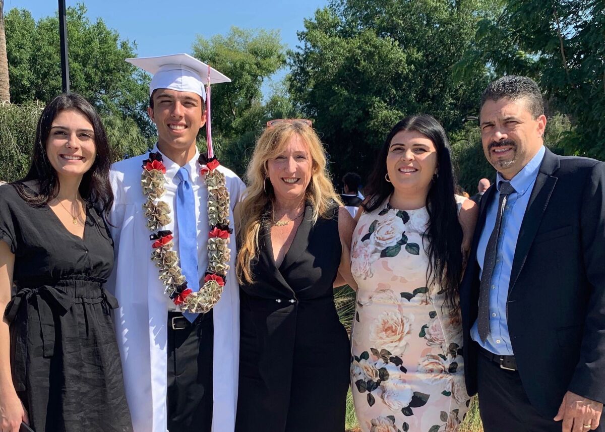 Dylan Hernandez with his sisters Julia and Kayla and his parents, Bart and Sylvie, at his high school graduation in Florida. Courtesy of Hernandez family