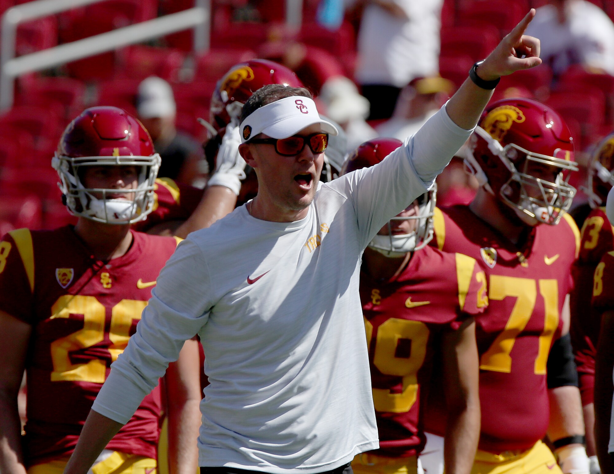 USC coach Lincoln Riley pumps up his players before Saturday's victory over Rice at the Coliseum.