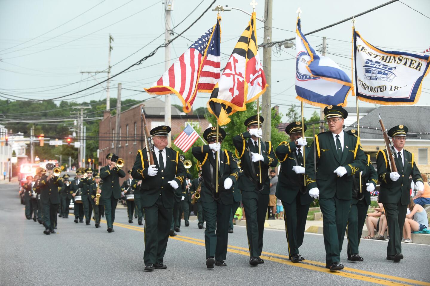 A flag squad leads the musicians in the Westminster Municpal Band as they perform in the parade leading to the Manchester Volunteer Fire Company carnvial on Tuesday, July 2.
