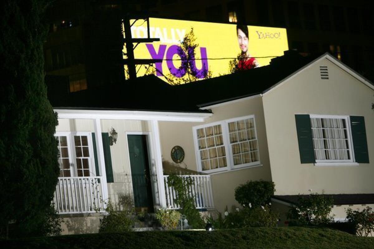 A home in Comstock Hills has a glow cast over it from a digital billboard on Santa Monica Boulevard.