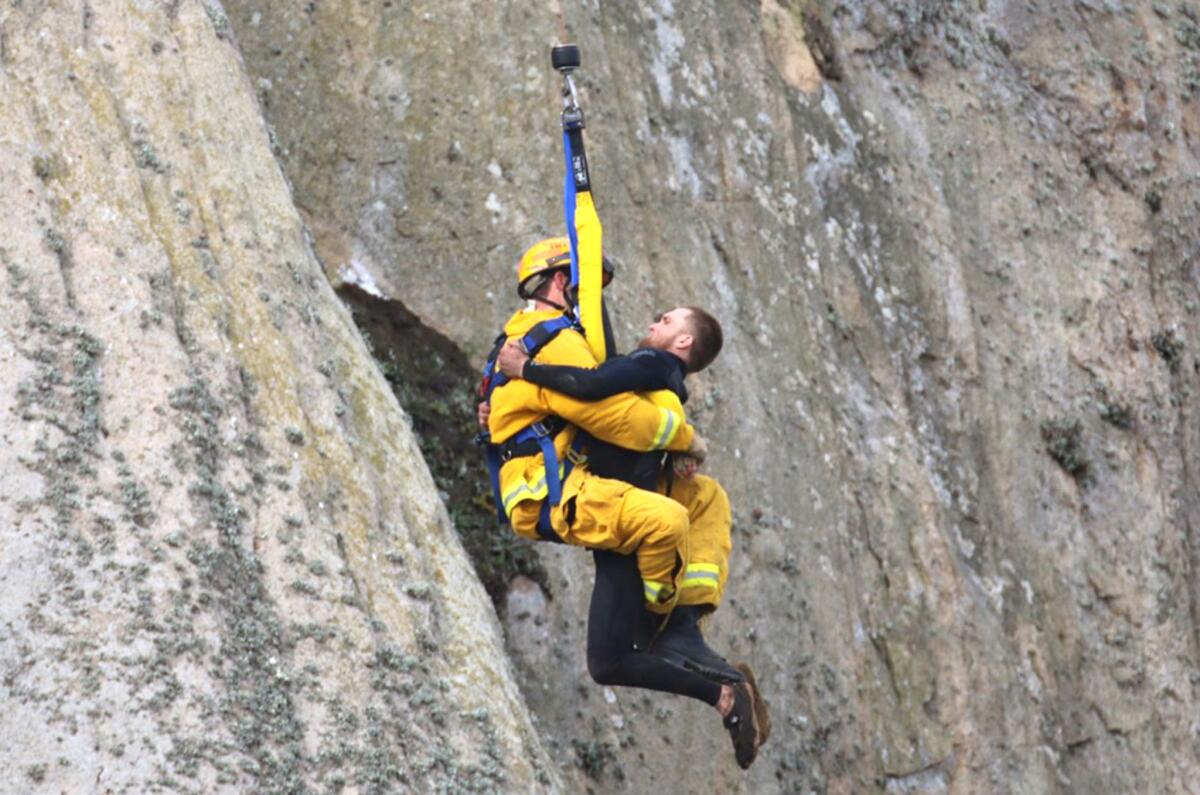 Michael Banks is rescued on Thursday after being stranded on a ledge on Morro Rock.