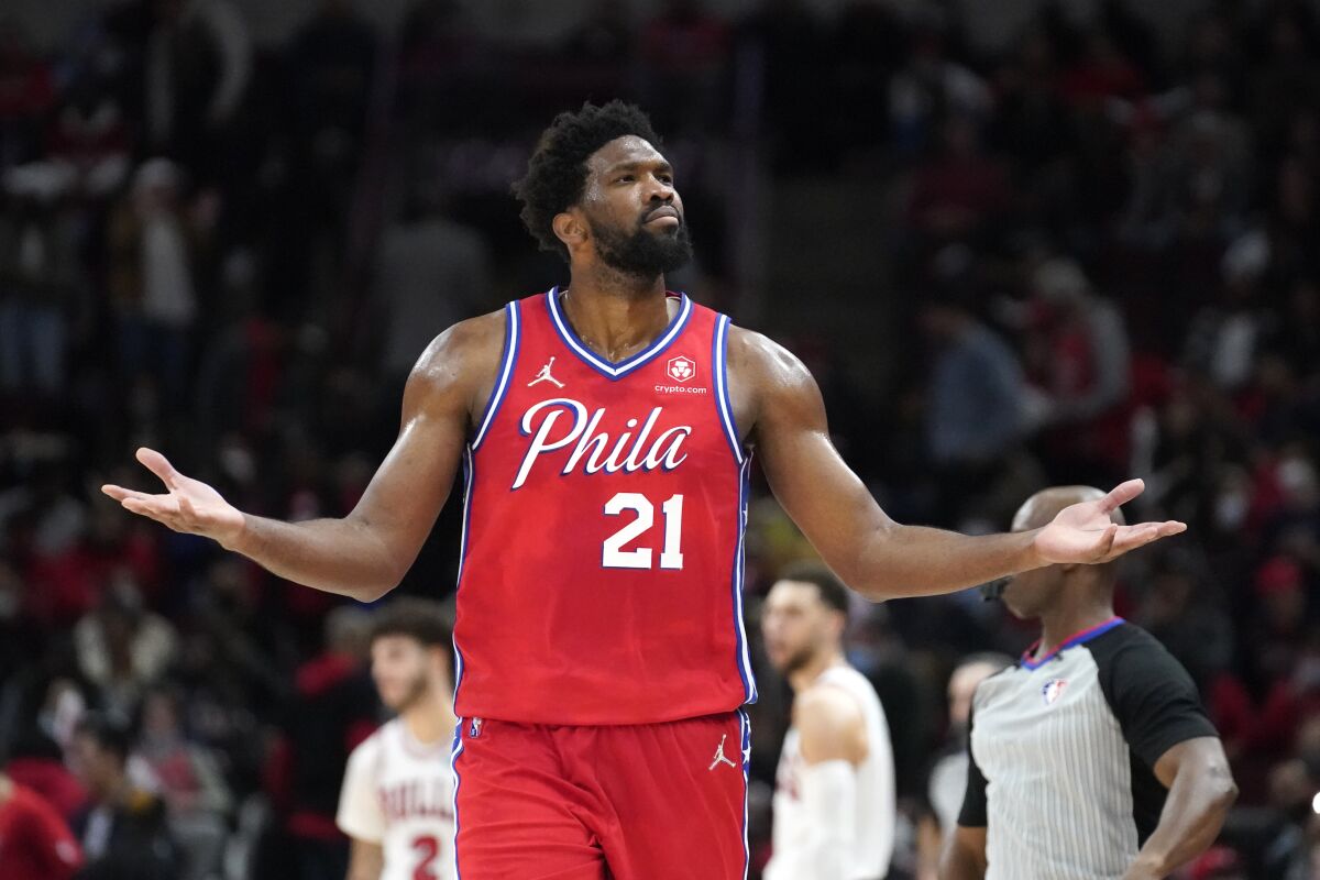 Philadelphia 76ers' Joel Embiid reacts to Chicago Bulls fans after hitting a 3-point shot late in the second half of the team's NBA basketball game against the Bulls on Saturday, Nov. 6, 2021, in Chicago. The 76ers won 114-105. (AP Photo/Charles Rex Arbogast)