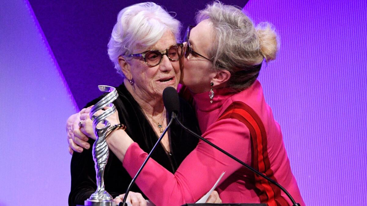 Designer Ann Roth, left, gets a kiss from Meryl Streep after giving Streep the Distinguished Collaborator Award during the 19th Costume Designers Guild Awards.