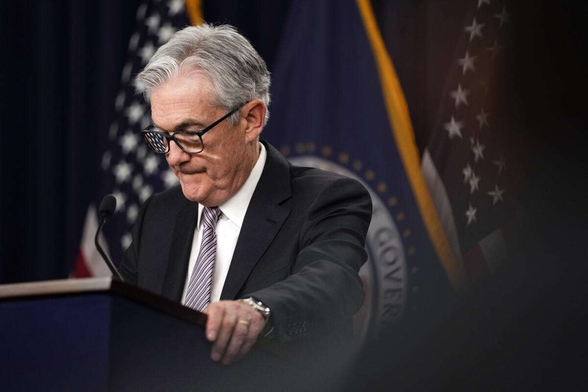 Federal Reserve Chairman Jerome Powell stands at a podium.