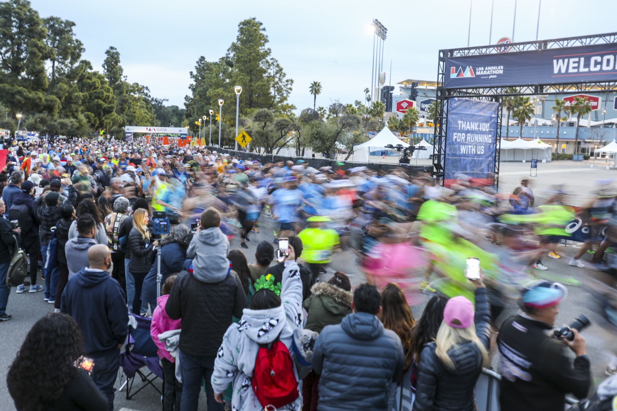 Undeterred by the weather, runners take to the streets for the 38th LA Marathon 7 Runners pass crowds of spectators at the LA Marathon